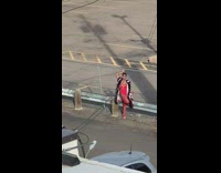 Red bodysuit stockings metal fence pose 