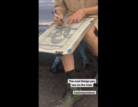 Woman makes drawing on newspaper article