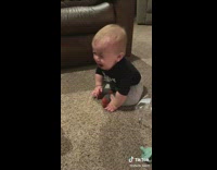Baby in black shirt cries when cactus toy screams at it