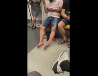 Guy barefoot white glasses face mask subway 