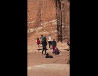 two women jump splits canyon background