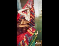 3 friends sit in hammocks over a bridge 