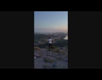 Man sings on top of the hill