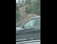 Guys sticks out his finger and drive along the highway
