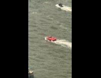 Man rides car in jet ski rally