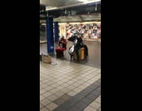 Silver skull and silver bird helmet playing cello violin in subway red dress black suit