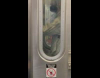 Man smoke e cigarette while stand in connector between subway cars