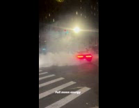 Car on intersection doing donuts 