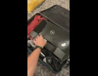 Guy packs dell computer screen blue suitcase 