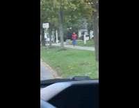 Man in spiderman costume runs at the park in the morning 