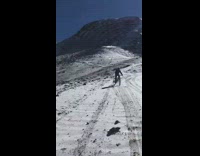 Guy tries to ride bike down snowy hill 