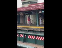 Man resistance bands workout at train station