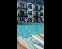 Collab IITW - Lady Holds Hat as she Walk Besides Pool