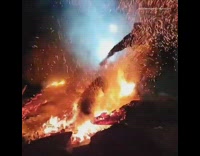 Guy on motorcycle tries to jump bonfire 