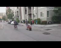 Skating with upright bass on wheels, downtown LA 