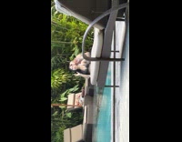 Old man films woman in bikini at pool