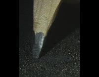 Guy scribbles black sandpaper red pencil