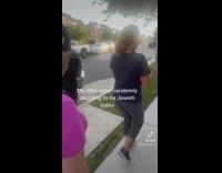 Two women following little girl in white yamaka