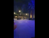 Two girls dance together outside 