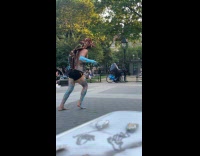 Man with paint on body dancing at park