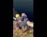 Two guys lays down under the bridge