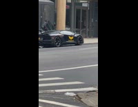 Black car with yellow batman decal 