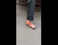 Woman wears five finger shoes at train
