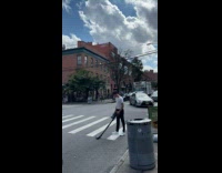 Man white shirt vacuum cleans the crosswalk