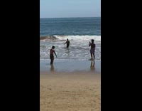 Guy bury feet in sand beach sing