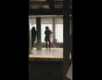 Woman dances in subway station while waiting for her train