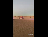 Guy watches police chase red car sand 
