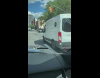 Grown man pedals on a trickle across street 