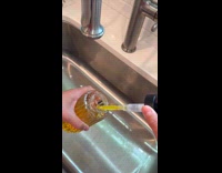 Woman fix soap dispenser using skewer stick
