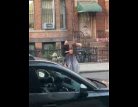 Man getting haircut on sidewalk