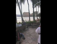 Men in hula outfits on beach