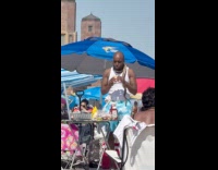 Man wears snake on neck eat burger