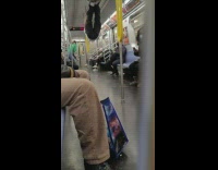 Guy tries to hang his feet from ceiling bars