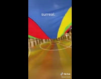 Colorful umbrella school game everyone lifts it and gets under 