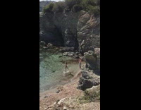 Woman in bikini jump at the beach shore