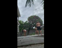 People rallying soccer ball in backyard and woman hit in face