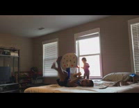 kid throws toy ball to hoop and and hits baby on face and makes shot