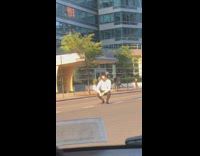 Guy photo phone tripod middle of road 