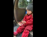 Little girl back of car laughing with her dad 