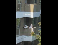 Woman laying on apartment balcony