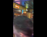 Man raps and sings Yeah! inside bar