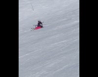 Woman slides down mountain holds skis