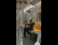 Man wear monitor on his head inside train at NY 