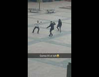 Three guys fight outside white shirt belt 