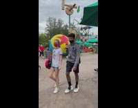 Girl poses by large toy story ball 