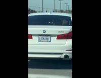 White BMW car LOOK AWAY license plate